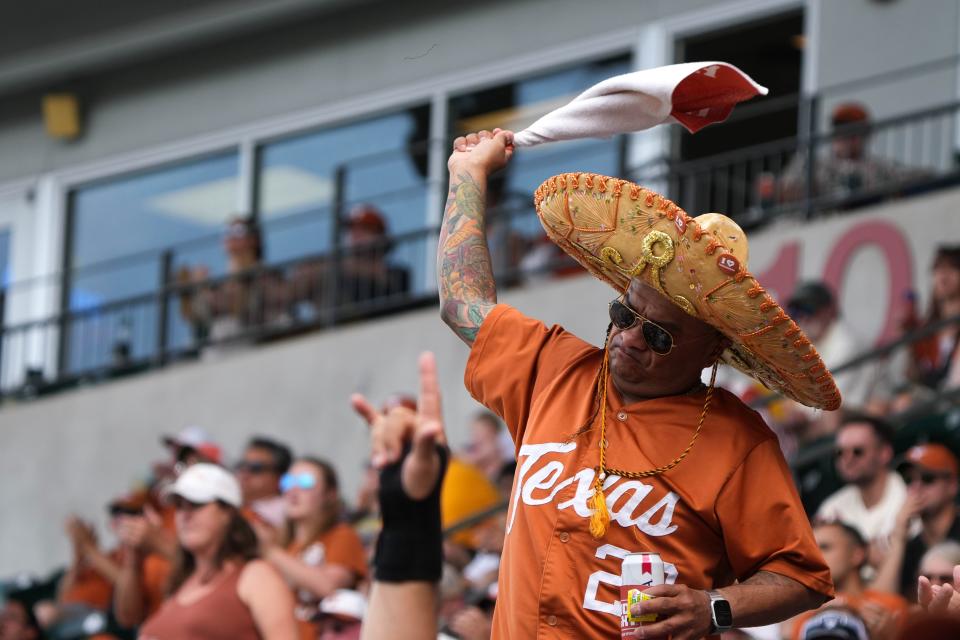 Texas fan Ron Ramirez celebrates a Longhorns run during Saturday's 7-3 win over West Virginia at UFCU Disch-Falk Field, which completed a series sweep and gave Texas a co-championship in the Big 12 along with the Mountaineers and Oklahoma State.