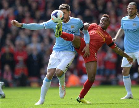 Liverpool's Raheem Sterling (R) challenges Manchester City's Javi Garcia during their English Premier League soccer match at Anfield in Liverpool, northern England April 13, 2014. REUTERS/Nigel Roddis