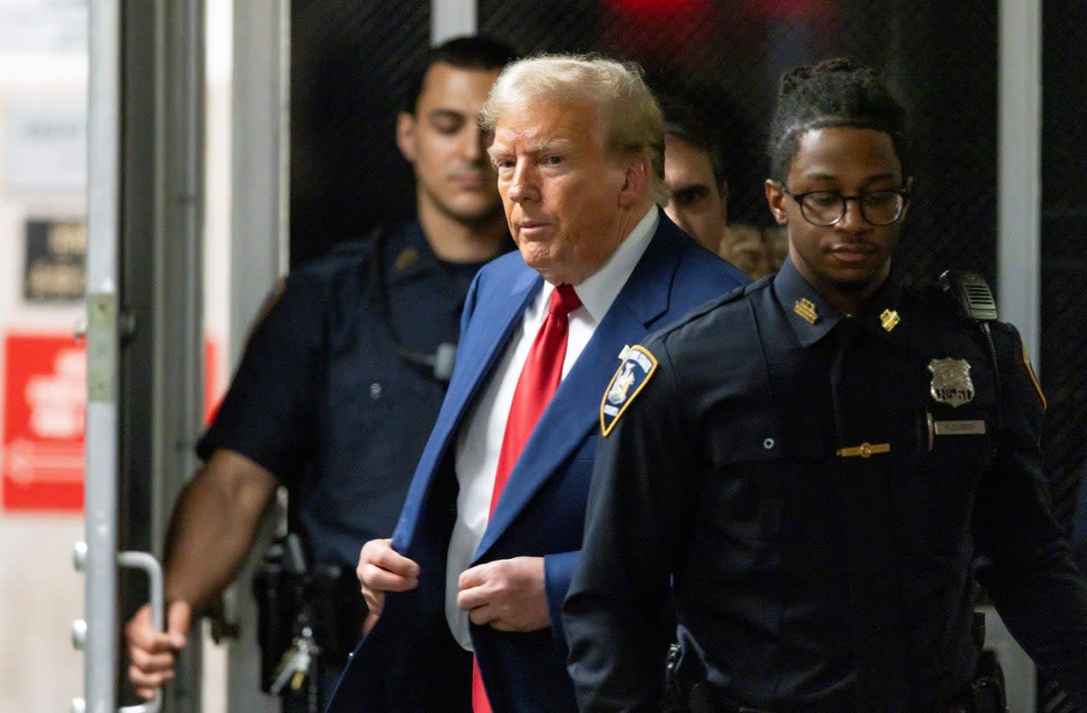 Former US president Donald Trump walks out of court to speak to the press during a break in his trial at Manhattan Criminal Court on 30 April 2024 (POOL/AFP via Getty Images)