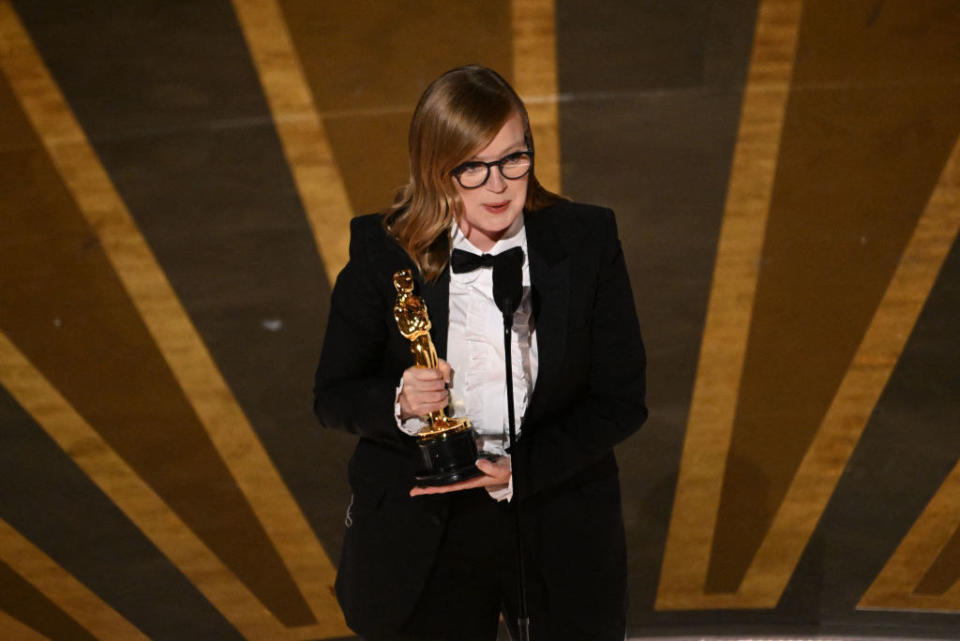 Sarah Polley accepts the Oscar for Best Adapted Screenplay for "Women Talking" onstage