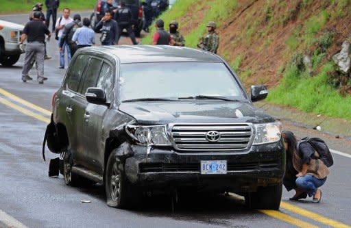 Forensic personnel check a US diplomatic vehicle attacked with gunfire in the Tres Marias-Huitzilac highway in Morelos, Mexico. The Mexican government said federal police shot at the vehicle as they were chasing criminals