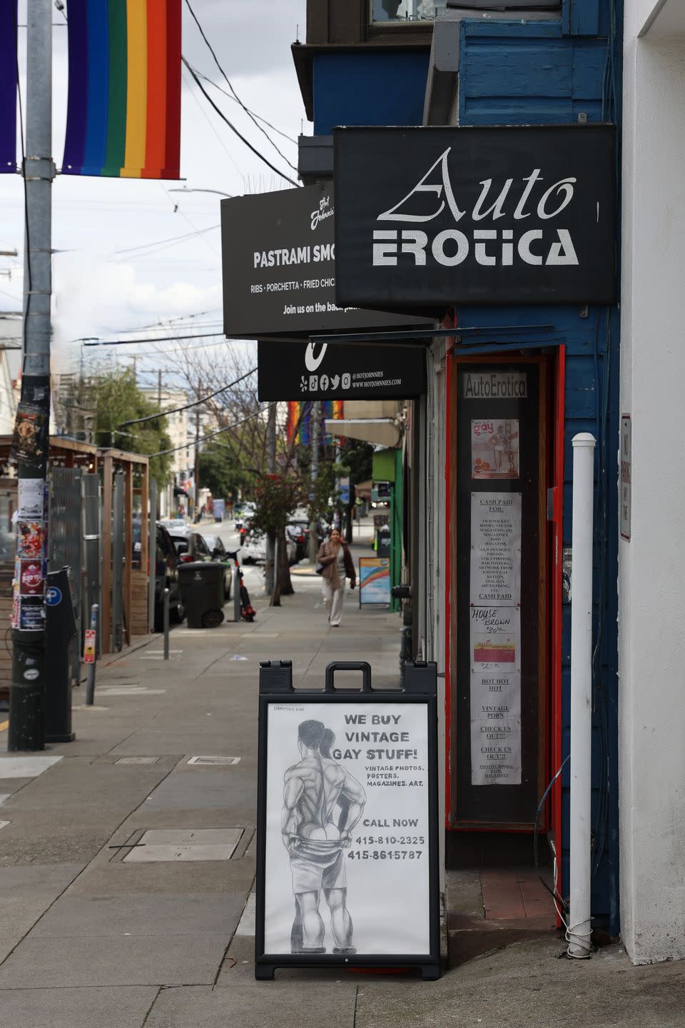 a sidewalk with signs and posters