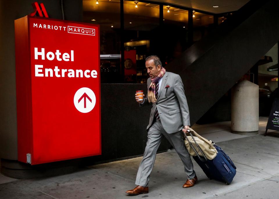 FILE PHOTO: A guest arrives at the Marriott Marquis hotel in Times Square in New York City, U.S., November 8, 2017. REUTERS/Brendan McDermid