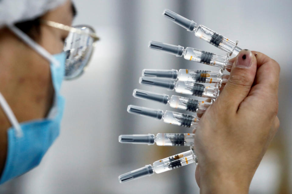 A worker performs a quality check in the packaging facility of Chinese vaccine maker Sinovac Biotech, developing an experimental coronavirus disease vaccine, during a government-organised media tour in Beijing, China, September 24, 2020. — Reuters pic