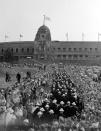 FILE - In this July 29, 1948 file photo, American contingent pass through the crowd and prepare to enter Wembley Stadium, for the grand parade of all competitors during the opening ceremony of the XIV Summer Olympic Games. London was still cleaning up bombing damage from World War II when it staged the Olympics in 1948. Britain was also struggling financially; food, clothing and gas were still being rationed. The athletes had to bring their own towels and, with housing in short supply, were accommodated in schools and Royal Air Force camps. The games were organized in less than two years, and despite the tiny budget it was a success, its legacies including greater sporting opportunities for women. (AP Photo, File)