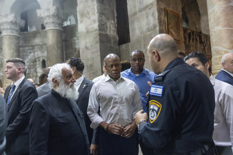 Mayor Eric Adams of New York, center, visits the Church of the Holy Sepulcher in Jerusalem, Tuesday, Aug. 22, 2023. Adams spent the second day of his visit to Israel touring holy sites before a planned meeting with Prime Minister Benjamin Netanyahu as he sought to avoid publicly weighing into the political crises plaguing the nation. (AP Photo/Ohad Zwigenberg)