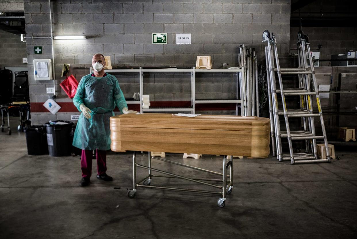 <span class="caption">The mortuary in Girona, Spain, one of the countries hardest hit by coronaviurs. </span> <span class="attribution"><a class="link " href="https://www.gettyimages.com/detail/news-photo/worker-stands-next-to-a-coffin-at-the-mortuary-in-girona-news-photo/1209215783?adppopup=true" rel="nofollow noopener" target="_blank" data-ylk="slk:Marti Navarro/SOPA Images/LightRocket via Getty Images;elm:context_link;itc:0;sec:content-canvas">Marti Navarro/SOPA Images/LightRocket via Getty Images</a></span>
