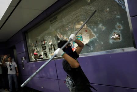 Anti-extradition bill protesters smash Mass Transit Railway (MTR) facility as they accuse the railway operator for helping the government to catch protesters, at Tung Chung, in Hong Kong