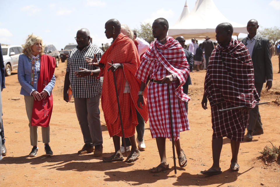US first Lady Jill Biden, left, greets members of the Maasai community as they explain the drought situation in Ngatataek, Kajiado Central, Kenya, Sunday, Feb. 26, 2023. Biden is in Kenya on the second and final stop of her trip. (AP Photo/Brian Inganga)