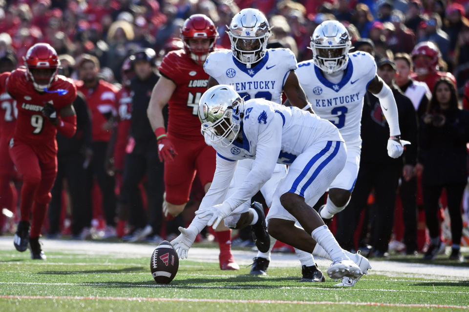 Kentucky linebacker J.J. Weaver (13) recovers a fumble during the second half of an NCAA college football game against Louisville in Louisville, Ky., Saturday, Nov. 25, 2023. Kentucky won 38-31. (AP Photo/Timothy D. Easley)