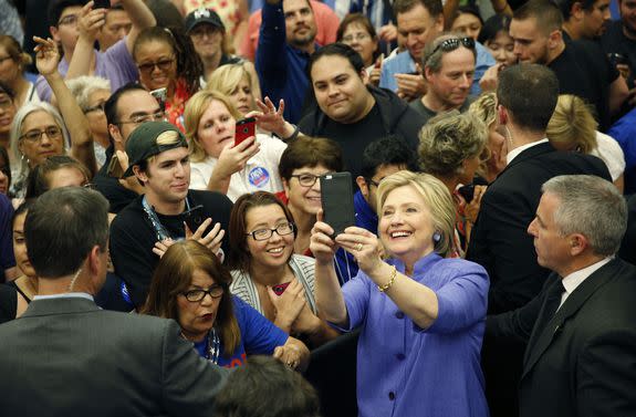 Hillary Clinton cheesing for a selfie with a group of supporters at a rally at California State University on June 3, 2016.