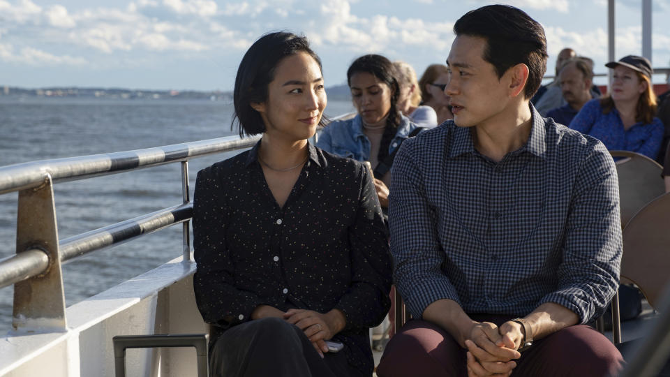 This image released by A24 shows Greta Lee, left, and Teo Yoo in a scene from "Past Lives." (Jon Pack/A24 via AP)