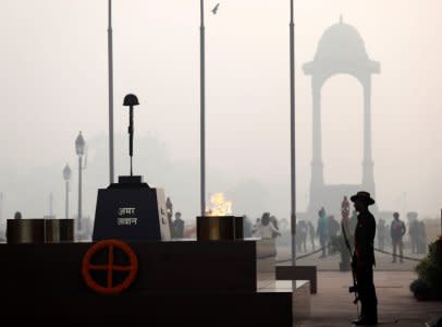 FILE PHOTO: A soldier stands guard next to Amar Jawan Jyoti at the India Gate war memorial on a smoggy winter morning in New Delhi, India, December 26, 2017. REUTERS/Saumya Khandelwal