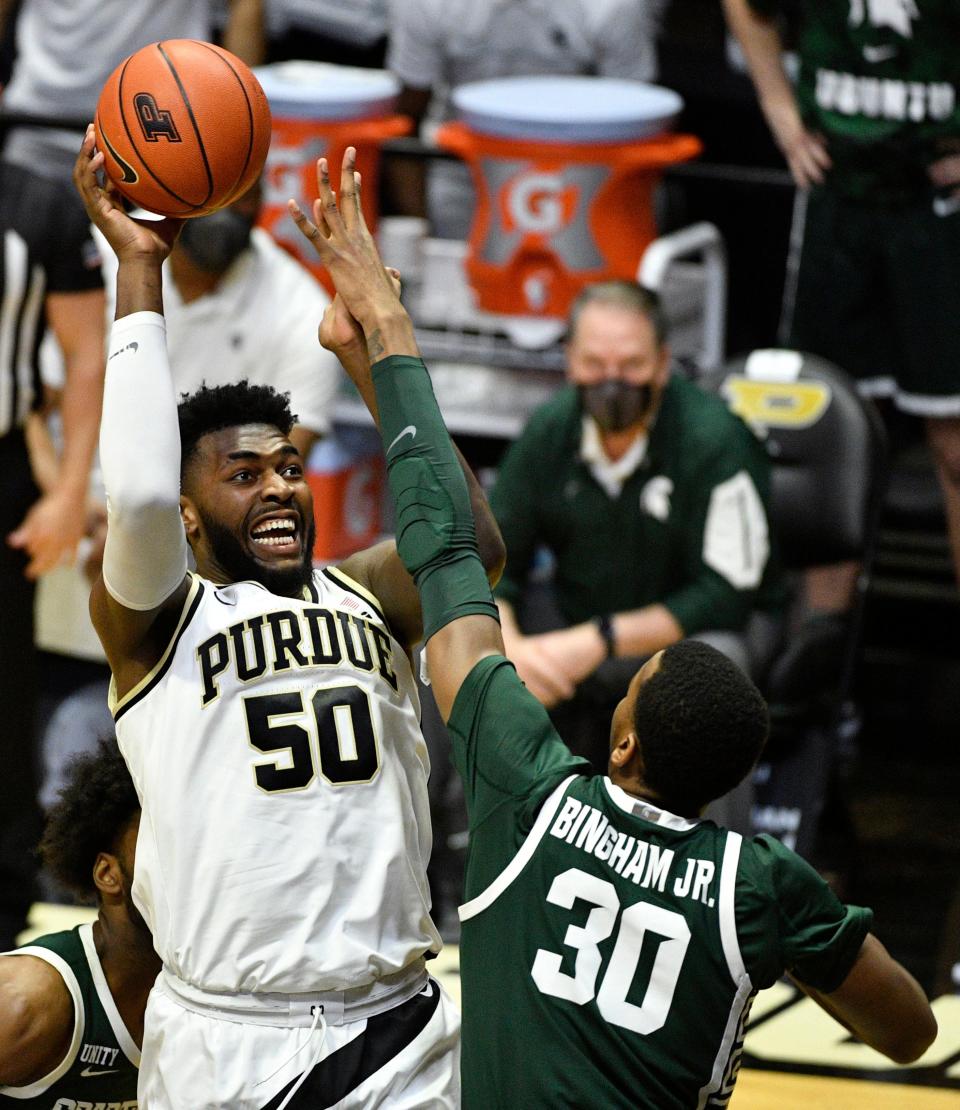 Feb 16, 2021; West Lafayette, Indiana, USA;  Purdue Boilermakers forward Trevion Williams (50) takes a shot over Michigan State Spartans forward Marcus Bingham Jr. (30) during the first half f the game at Mackey Arena. Mandatory Credit: Marc Lebryk-USA TODAY Sports