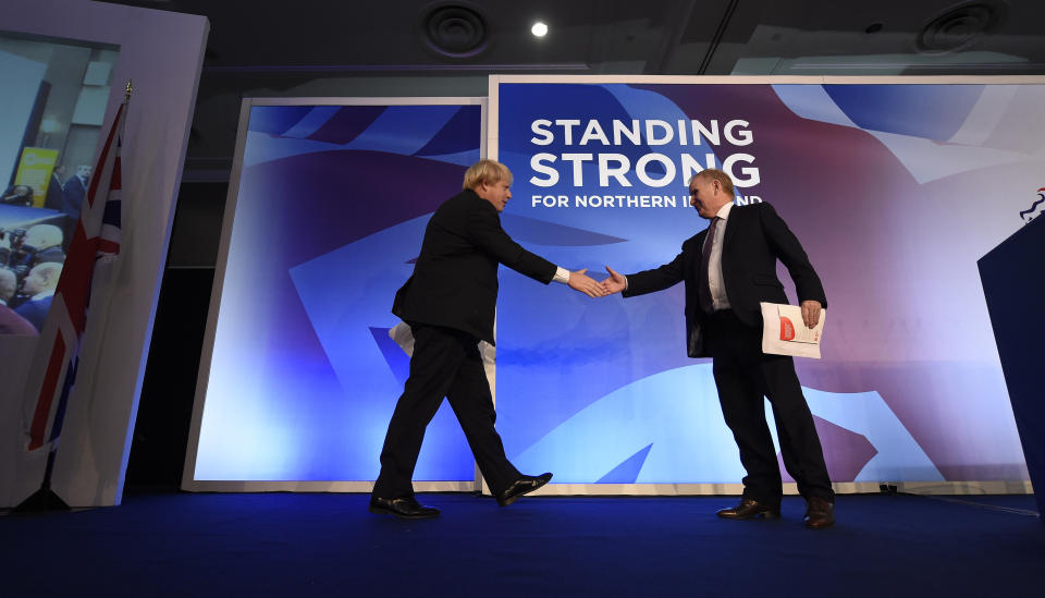 Boris Johnson (left), guest speaker during the DUP annual conference is welcomed onto the stage by Lord Morrow, DUP Chairman at the Crown Plaza Hotel in Belfast.