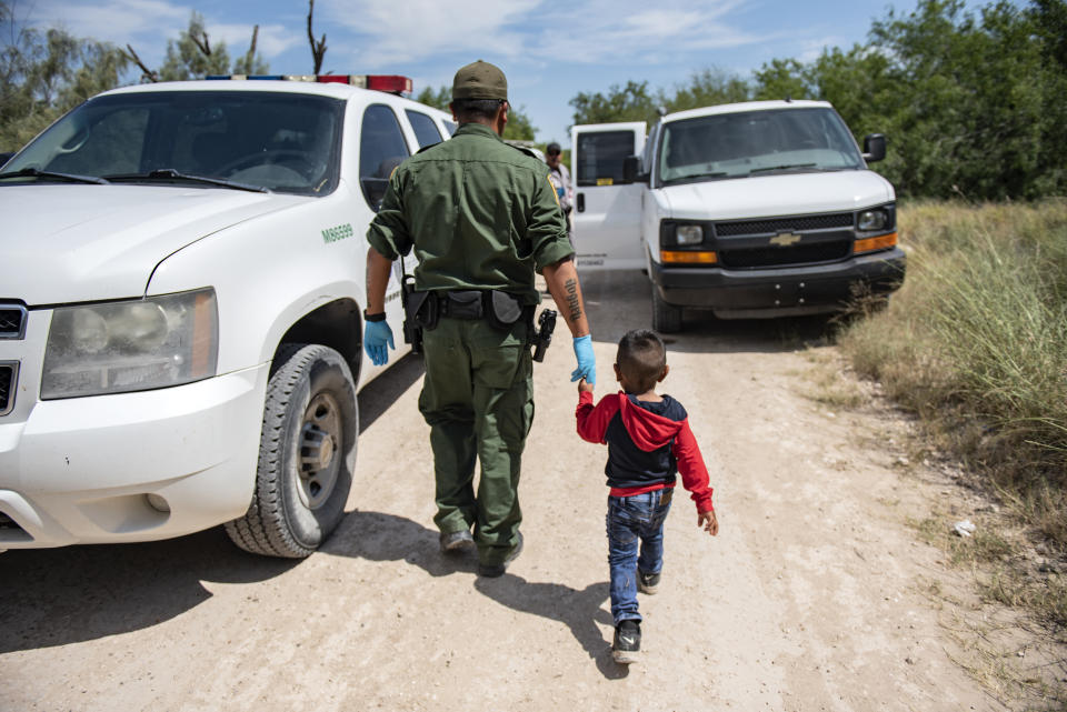 Border Patrol agent Roy Ramirez with immigrant boy