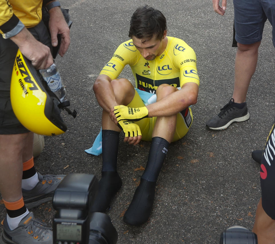 Slovenia's Primoz Roglic sits on the tarmac after losing the overall leader's yellow jersey in stage 20 of the Tour de France cycling race, an individual time trial over 36.2 kilometers (22.5 miles), from Lure to La Planche des Belles Filles, France, Saturday, Sept. 19, 2020. (AP Photo/Thibault Camus, Pool)