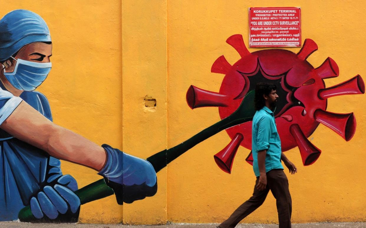 A man walks past a Covid-19 coronavirus awareness mural along the roadside in Chennai, India - Sri Loganathan/Zuma Press / eyevine