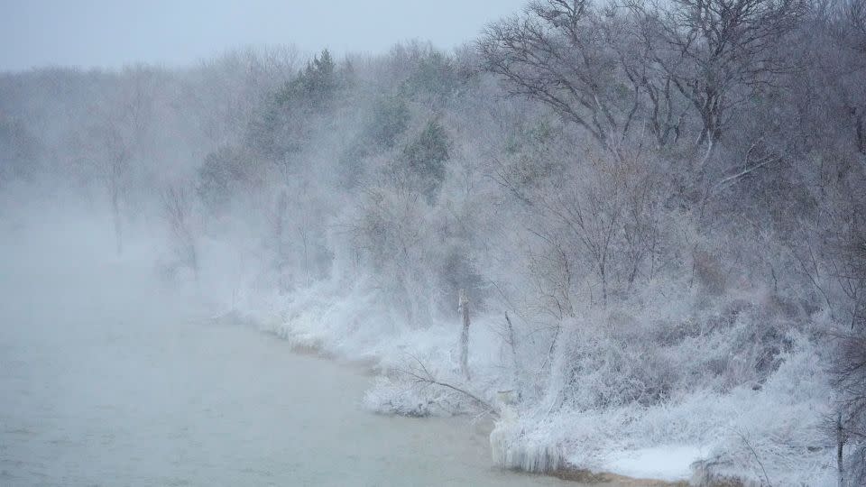 Snow covers the shore of Joe Pool Lake during a winter storm in Grand Prairie, Texas. - Julio Cortez/AP