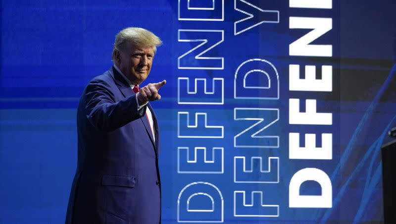 Former President Donald Trump points to the crowd during a speaking appearance at the National Rifle Association Convention in Indianapolis, Friday, April 14, 2023.