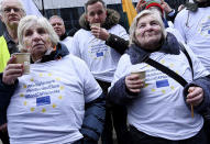 Farmers from the Baltic's demonstrate outside of an EU summit in Brussels, Thursday, Feb. 20, 2020. Baltic farmers on Thursday were calling for a fair allocation of direct payments under the European Union's Common Agricultural Policy. (AP Photo/Riccardo Pareggiani)