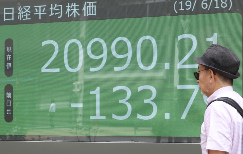 A man walks by an electronic stock board of a securities firm in Tokyo, Tuesday, June 18, 2019. Stocks in Asia mostly advanced Tuesday ahead of interest rate decisions by the U.S. Federal Reserve and other central banks. (AP Photo/Koji Sasahara)