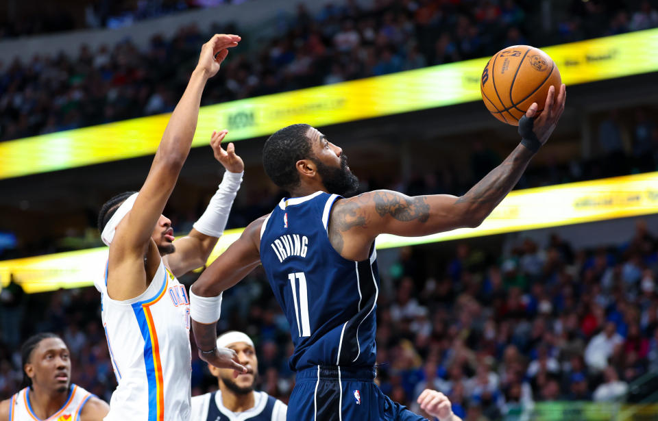 Feb 10, 2024; Dallas, Texas, USA; Dallas Mavericks guard Kyrie Irving (11) drives to the basket past Oklahoma City Thunder guard <a class="link " href="https://sports.yahoo.com/nba/players/6597/" data-i13n="sec:content-canvas;subsec:anchor_text;elm:context_link" data-ylk="slk:Aaron Wiggins;sec:content-canvas;subsec:anchor_text;elm:context_link;itc:0">Aaron Wiggins</a> (21) during the second half at American Airlines Center. Mandatory Credit: Kevin Jairaj-USA TODAY Sports