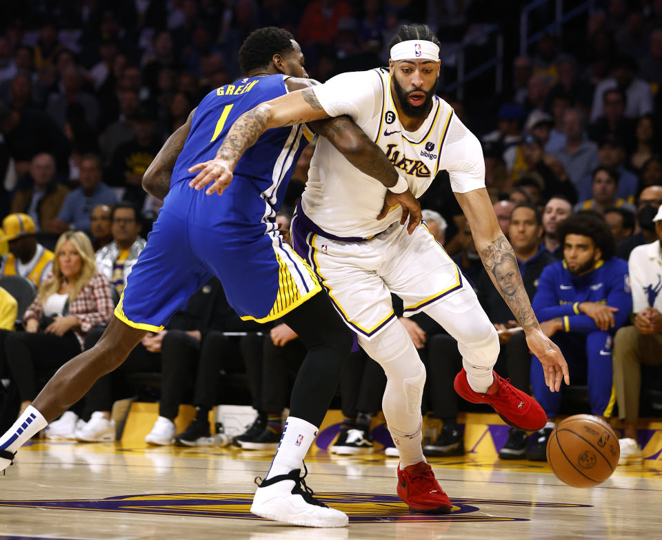 Los Angeles Lakers center Anthony Davis dribbles around the Golden State Warriors' JaMychal Green in Game 3 of the Western Conference semifinal series at Crypto.com Arena in Los Angeles on May 6, 2023. (Ronald Martinez/Getty Images)