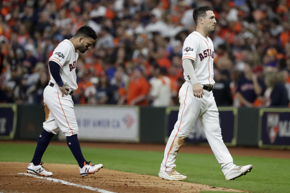 Houston Astros' Jose Altuve, left, and Alex Bregman walk to the dugout after a double play ends the seventh inning in Game 1 of baseball's American League Championship Series against the New York Yankees Saturday, Oct. 12, 2019, in Houston. (AP Photo/Eric Gay)