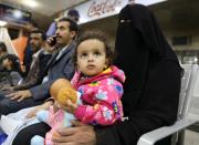 People wait to board a United Nations plane which will carry them and other patients to Amman, Jordan in the first flight of a medical air bridge from Sanaa airport in Sanaa, Yemen