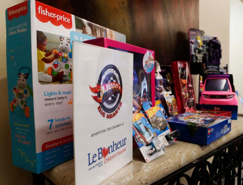 Donated brand-new toys sit on a table inside Pinnacle Financial for Shaun Smith’s Little Wheels Big Hearts of Tennessee toy drive for Le Bonheur Children’s Hospital at the Poplar and Highland location on Wednesday, Nov. 15, 2023, in Memphis, Tenn.