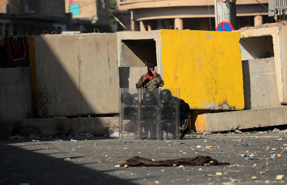Riot police close al-Rashid St. during clashes with anti-government demonstrators, in Baghdad, Iraq, Sunday, Nov. 17, 2019. (AP Photo/Hadi Mizban)