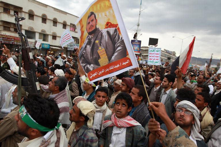 Yemeni supporters of the Shiite Huthi militia hold a portrait the movement's leader, Abdul-Malik al-Huthi, on March 26, 2015, during a gathering in Sanaa to show support the militia and against the Saudi-led intervention in the country