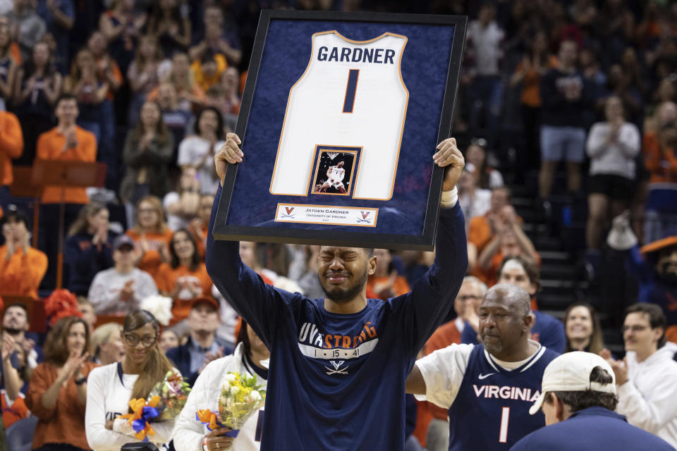 Virginia's Jayden Gardner (1) becomes emotional before an NCAA college basketball game against Louisville in Charlottesville, Va., Saturday, March 4, 2023. (AP Photo/Mike Kropf)