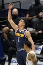 Denver Nuggets forward Michael Porter Jr. (1) celebrates sinking a 3-point basket as Dallas Mavericks' Trey Burke, bottom, walks past in the second half of an NBA basketball game in Dallas, Monday, Jan. 25, 2021. (AP Photo/Tony Gutierrez)