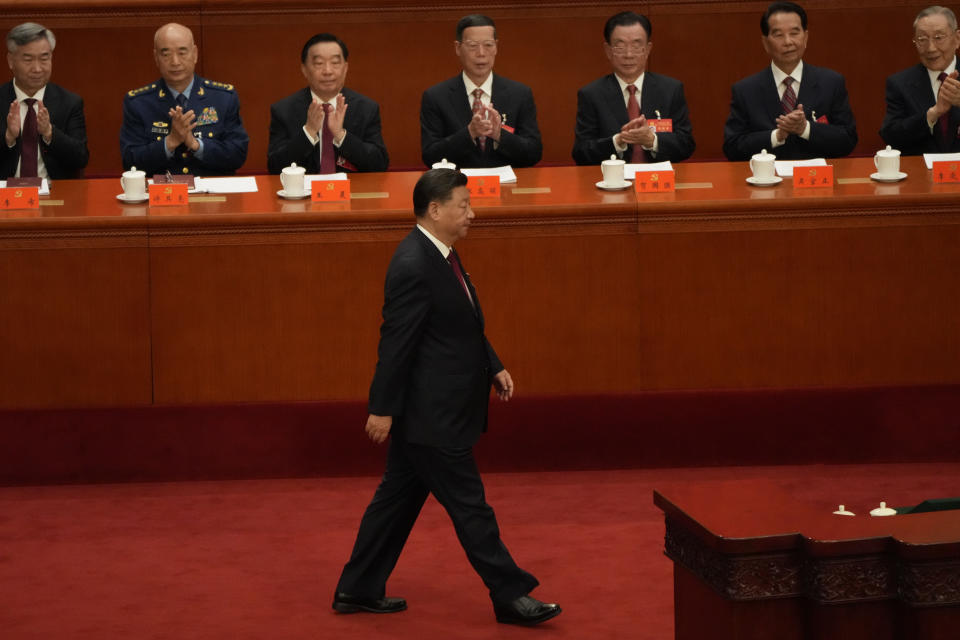 Chinese President Xi Jinping walks to the podium to give a speech at the opening ceremony of the 20th National Congress of China's ruling Communist Party held at the Great Hall of the People in Beijing, China, Sunday, Oct. 16, 2022. China on Sunday opens a twice-a-decade party conference at which leader Xi Jinping is expected to receive a third five-year term that breaks with recent precedent and establishes himself as arguably the most powerful Chinese politician since Mao Zedong. (AP Photo/Mark Schiefelbein)