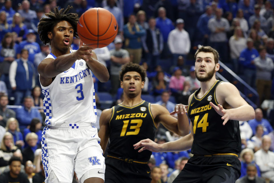 Kentucky's Tyrese Maxey (3) passes around the defense of Missouri's Mark Smith (13) and Reed Nikko (14) during the first half of an NCAA college basketball game in Lexington, Ky., Saturday, Jan 4, 2020. (AP Photo/James Crisp)