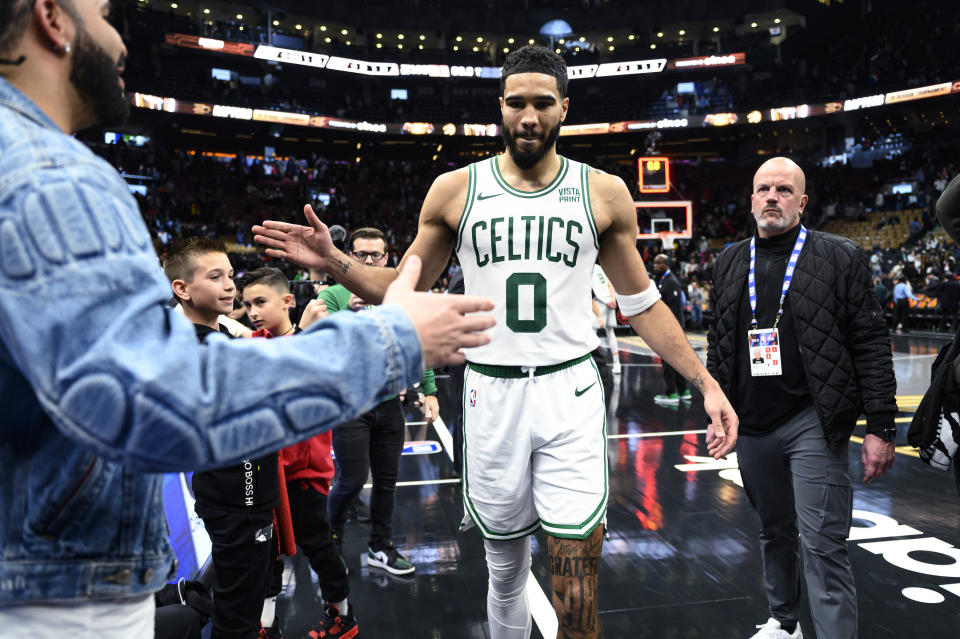 Boston Celtics forward Jayson Tatum (0) greets Drake after the Celtics defeated the Toronto Raptors in an NBA basketball game Friday, Nov. 17, 2023, in Toronto. (Christopher Katsarov/The Canadian Press via AP)