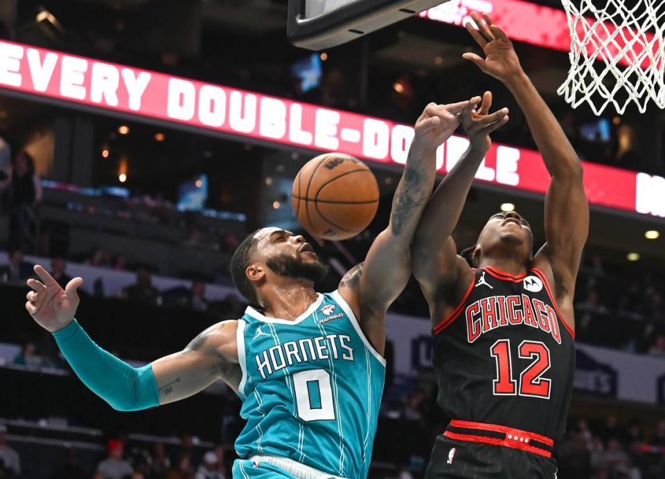 Charlotte Hornets forward Miles Bridges stops Chicago Bulls guard Ayo Dosunmu, right, on a drive to the basket during first half action on Monday, January 8, 2024 at Spectrum Center in Charlotte, NC.