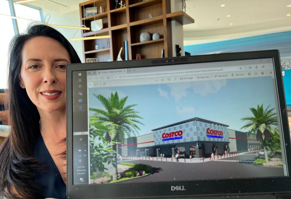 One Daytona President Roxanne Ribakoff holds up a laptop computer showing a rendering of the Costco Wholesale store currently under construction in the northwest corner of the entertainment/retail center's parking lot on Wednesday, Sept. 6, 2023. The membership warehouse club store is on track to open in early 2024.