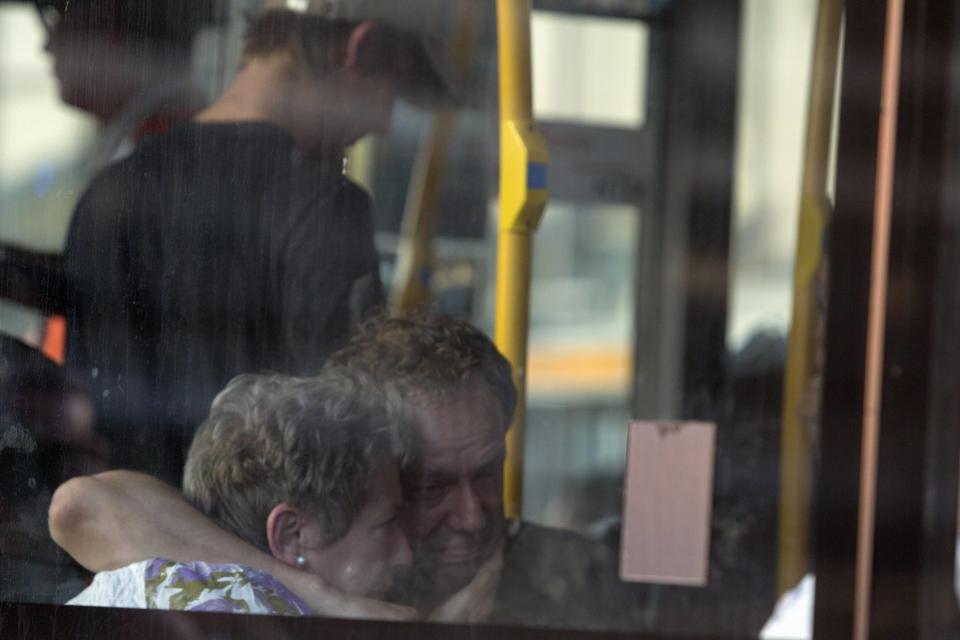 Family members of passengers on Malaysia Airlines flight MH17 react on a bus bringing them to a separate area at Schiphol Airport July 17, 2014. The Malaysian airliner was brought down over eastern Ukraine on Thursday, killing all 295 people aboard and sharply raising the stakes in a conflict between Kiev and pro-Moscow rebels in which Russia and the West back opposing sides. REUTERS/Cris Toala Olivares (NETHERLANDS - Tags: TRANSPORT DISASTER)