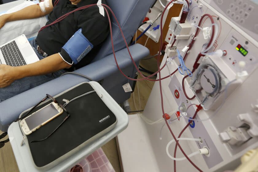 FILE - A patient undergoes kidney dialysis at a clinic in Sacramento, Calif., on Sept. 24, 2018. A state ballot measure would require a doctor, nurse practitioner or physicians' assistant to be present during treatment at an outpatient kidney dialysis clinic. This will be the third consecutive general election where voters have been asked this question. The two previous measures failed. This measure is backed again by labor unions who represent health care workers. And again, kidney dialysis companies are opposing it. Some have suggested the subtext of these ballot initiatives is a broader battle of labor unions attempting to organize workers at the state's more than 600 kidney dialysis clinics. (AP Photo/Rich Pedroncelli, File)