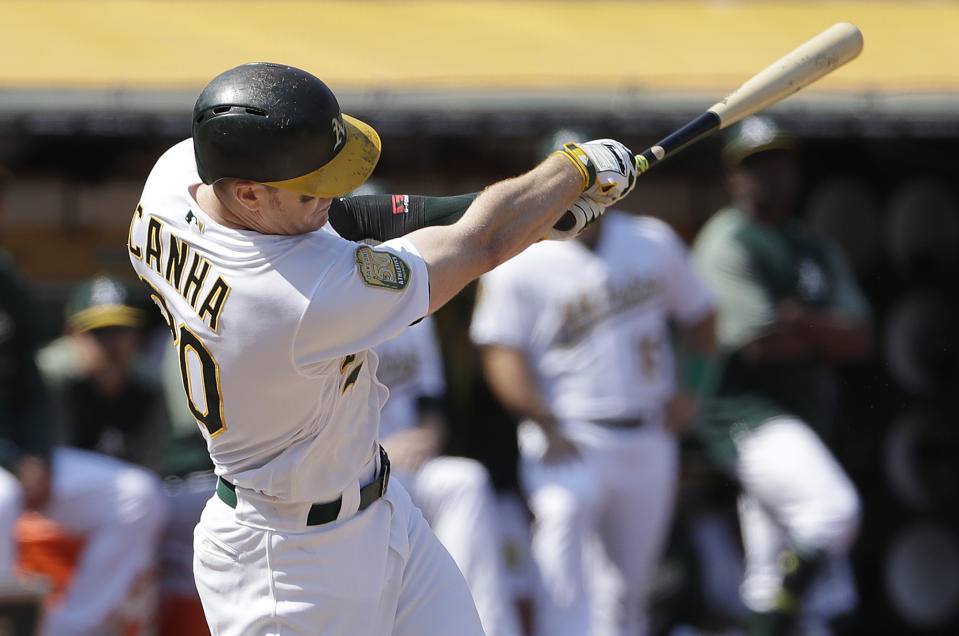 Oakland Athletics' Mark Canha hits a solo home run against the New York Yankees during the fifth inning of a baseball game in Oakland, Calif., Monday, Sept. 3, 2018. (AP Photo/Jeff Chiu)