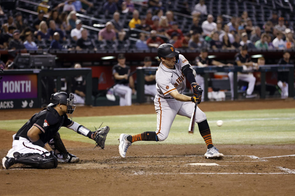 San Francisco Giants' Casey Schmitt hits a single against the Arizona Diamondbacks during the seventh inning of a baseball game Thursday, May 11, 2023, in Phoenix. (AP Photo/Chris Coduto)