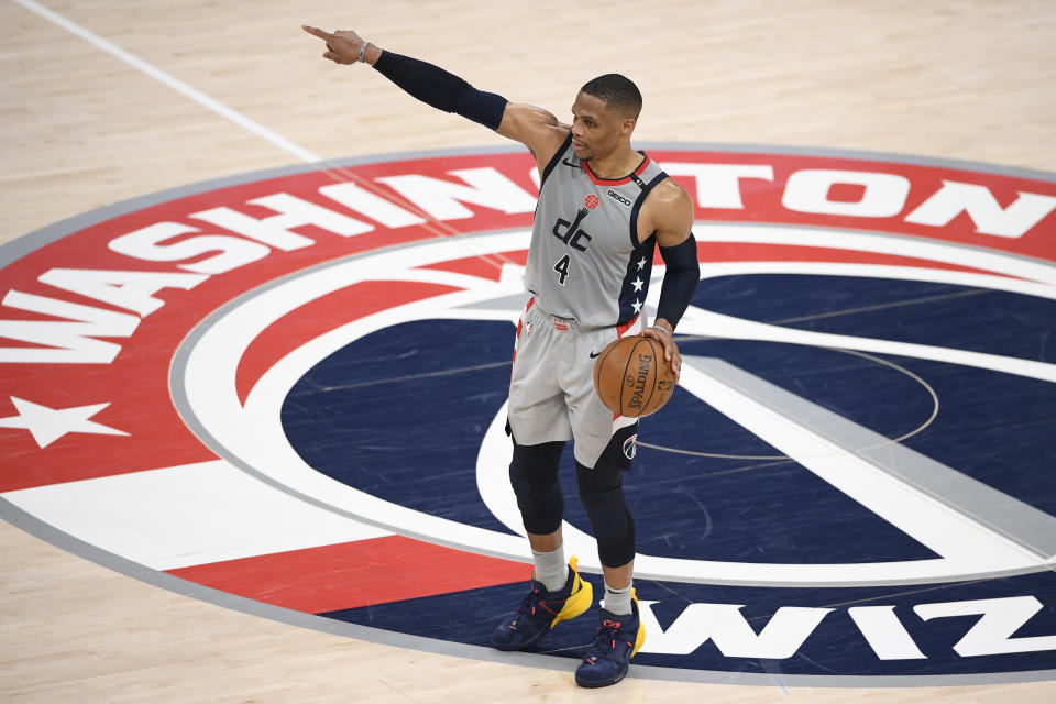 Washington Wizards guard Russell Westbrook (4) points as he dribbles during the first half of Game 3 in a first-round NBA basketball playoff series against the Philadelphia 76ers, Saturday, May 29, 2021, in Washington. (AP Photo/Nick Wass)