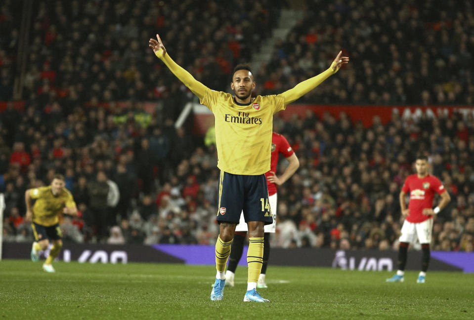 Arsenal's Pierre-Emerick Aubameyang celebrates after scoring the opening goal during the English Premier League soccer match between Manchester United and Arsenal at Old Trafford in Manchester, England, Monday, Sept. 30, 2019. (AP Photo/Dave Thompson)