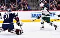 Jan 23, 2019; Denver, CO, USA; Minnesota Wild left wing Jason Zucker (16) shoots against Colorado Avalanche goaltender Philipp Grubauer (31) in the first period at the Pepsi Center. Mandatory Credit: Ron Chenoy-USA TODAY Sports