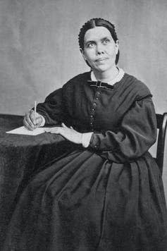 Black and white photo of woman writing