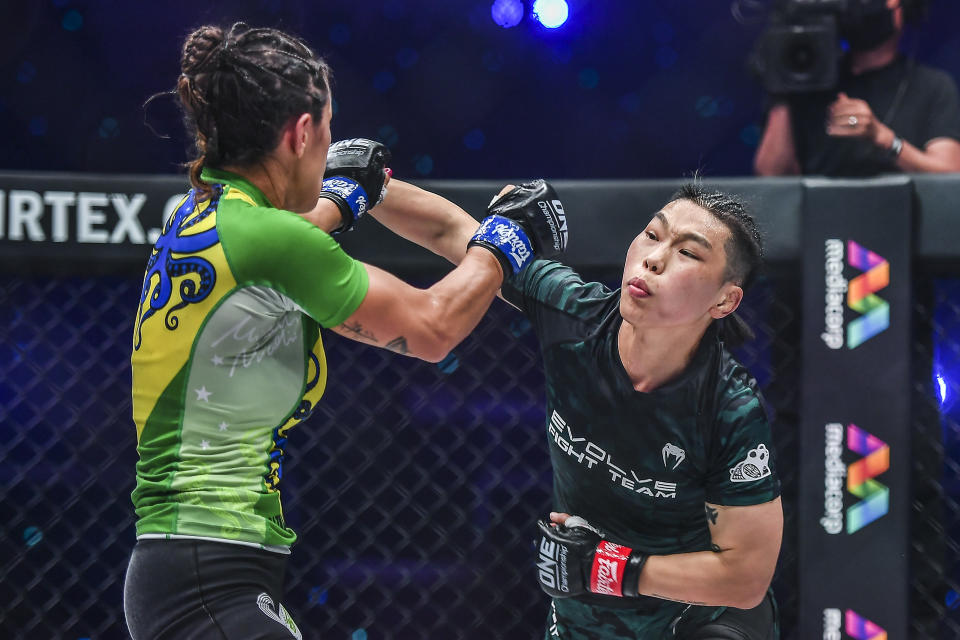 Xiong Jingnan (right) of China battles Brazil's Michelle Nicolini in their main-event bout at ONE: Empower. (PHOTO: ONE Championship)