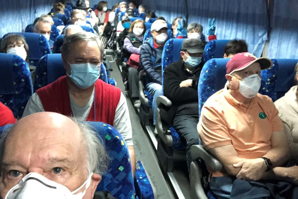 US passengers of the Diamond Princess cruise ship are transported by shuttle bus in Yokohama to Haneda airport to fly home on a chartered evacuation flight (via REUTERS)